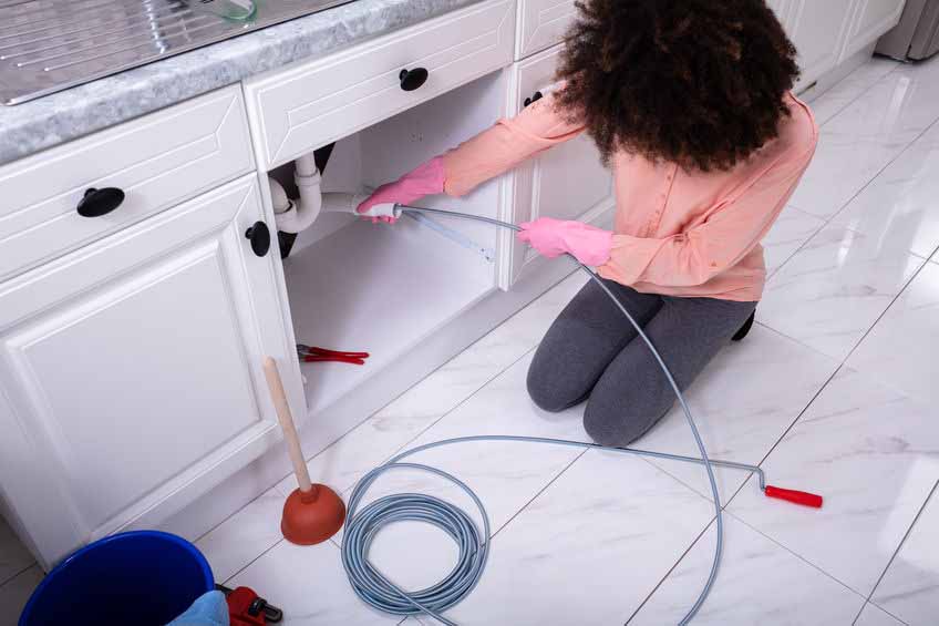 A Woman doing DIY Drain Cleaning